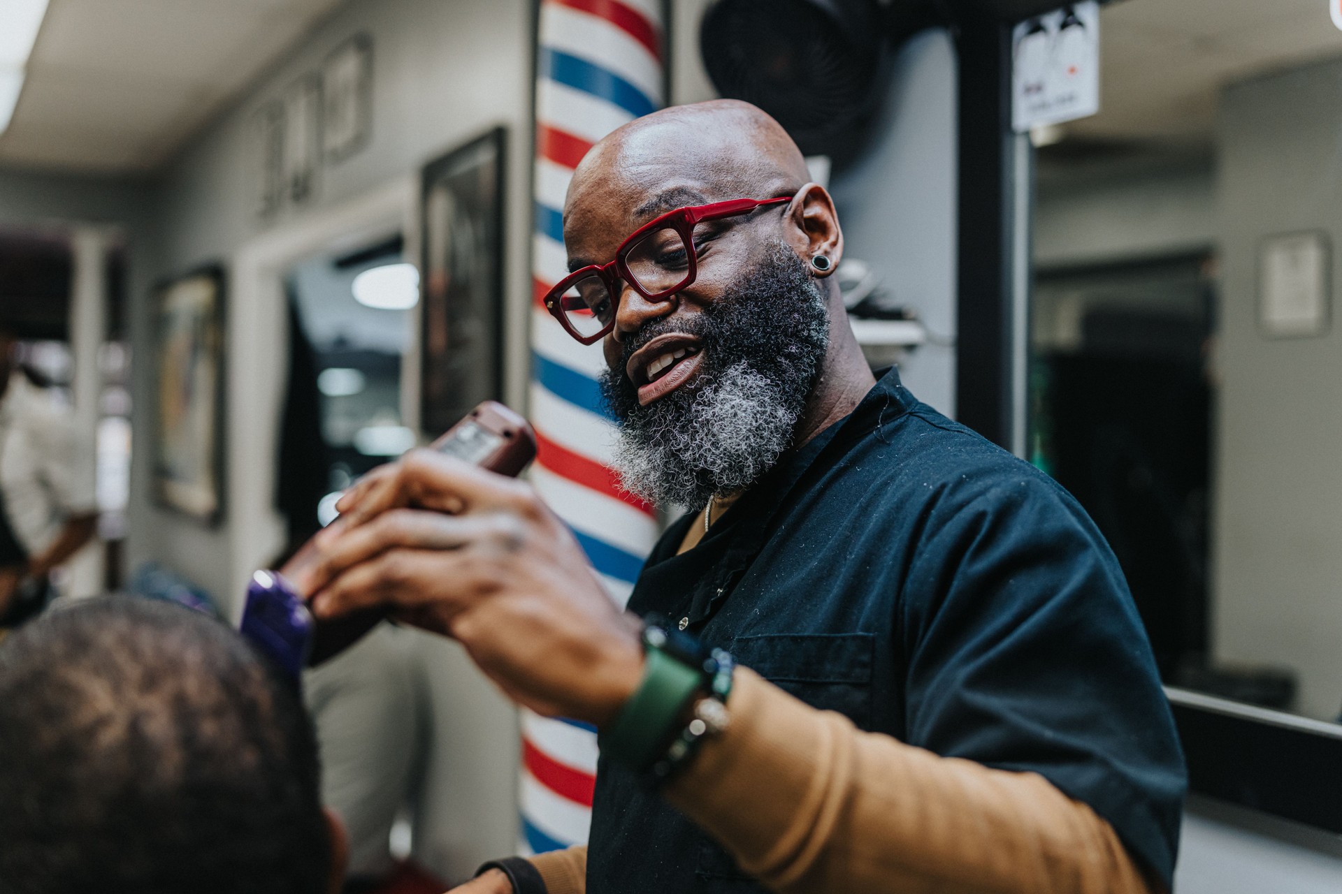Middle aged black man working in barber shop